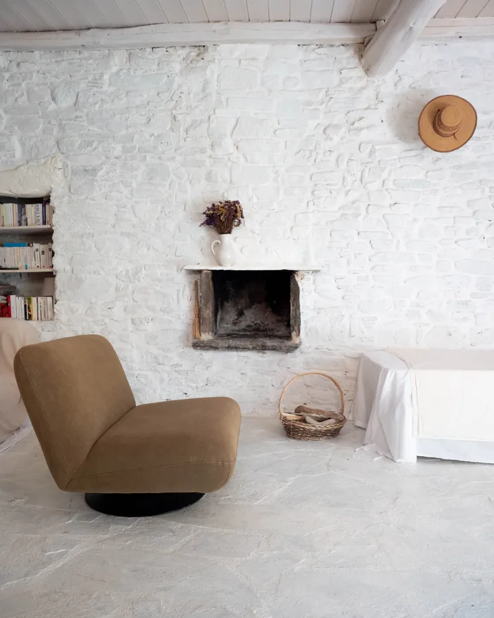 An armchair beside the fireplace