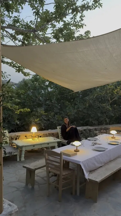 The terrace at dusk, under a shade sail
